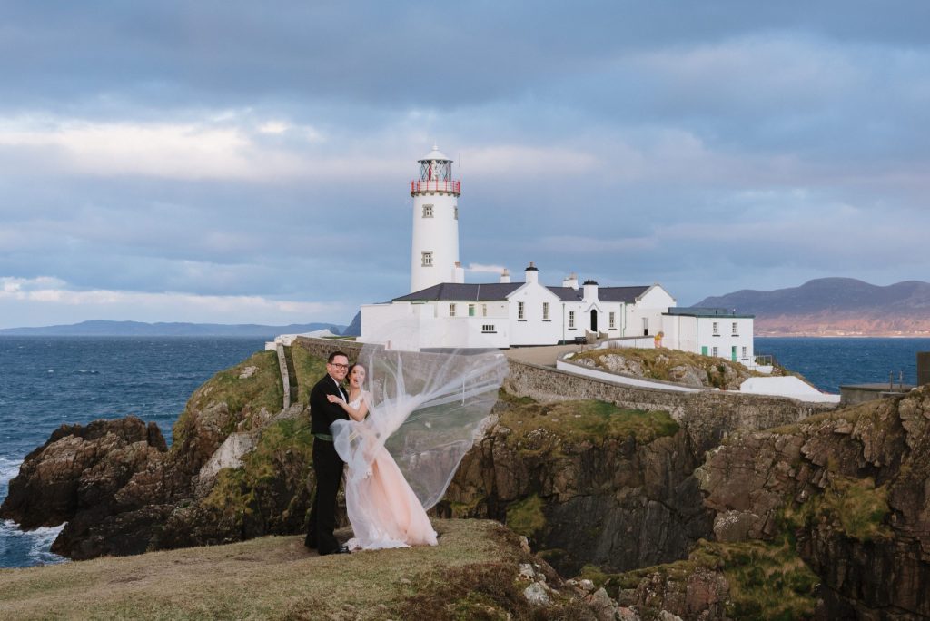 wedding photos of husband and wife in front of lighthouse