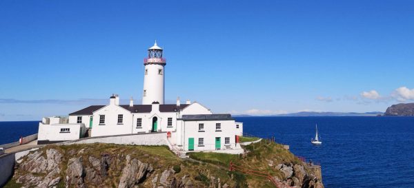 Fanad Lighthouse with sailboat